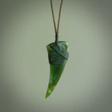 This is a lovely large New Zealand Jade, pounamu drop pendant. Hand carved for us by Ric Moor. It is bound with an adjustable khaki coloured cord which is length adjustable. Free worldwide shipping.