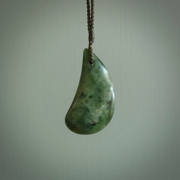 This photo shows a large jade drop shaped pendant. It a a lovely deep green jade. The cord is a four plait olive green and is adjustable in length. One only medium, contemporary drop necklace from Jade, by Ric Moor.