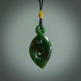 Ross Crump twist with koru pendant. Hand carved from rare New Zealand jade this is a beautiful pounamu pendant. The cord is hand plaited and is length adjustable. It has a little spiral floret popper at the top of the pendant. It is a delicate and very beautiful greenstone pendant. For sale online by NZ Pacific.