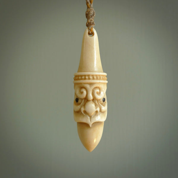 Hand carved incredible stained bone gargoyle face carving. A stunning work of art. This pendant was hand carved in bone with buffalo horn inlay for the eyes by Yuri Terenyi. A one off collectors item that has been hand crafted to be worn or displayed.