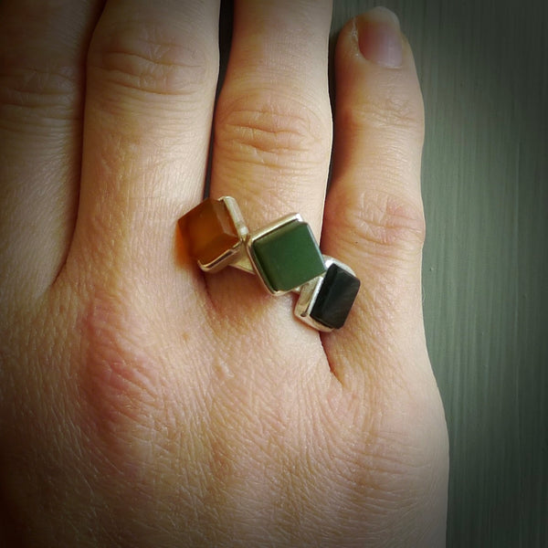 This is a handcrafted New Zealand Pounamu, Jade with Chalcedony and sterling silver ring. This is a solid little work of art. We ship this worldwide for free and are happy to answer any questions that you may have about these or other products on our website. Delivered with Express Courier in a woven kete pouch.
