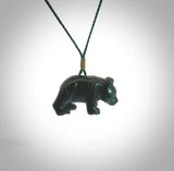 This picture shows a pendant that we designed in New Zealand jade. It is a little green bear that has a walking stance and is carved in detail. A really attractive and eye-catching piece of handmade jewellery. The cord is hand plaited braid in black and pale honey and the length can be adjusted.