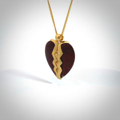 This is a handcarved love heart pendant made from a gorgeous and striking piece of red jasper stone with gold plated silver. This is a superbly carved and very unique piece if custom jewellery. For sale online from NZ Pacific.