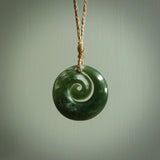 This pendant is a medium sized and gorgeous koru necklace carved from a deep green piece of New Zealand  Jade. Ross Crump carved this piece for us so the workmanship is outstanding. Handmade in New Zealand, a beautiful piece of jade jewellery.