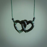 Hand carved double heart pendant made in black jade, green jade and jasper stone. Made by NZ Pacific. Carved from green jade, black jade and red jasper stone. Free delivery worldwide.