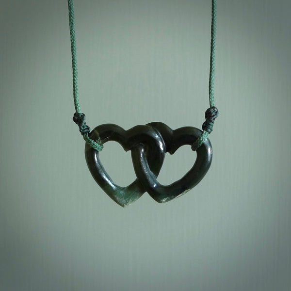 Hand carved double heart pendant made in black jade, green jade and jasper stone. Made by NZ Pacific. Carved from green jade, black jade and red jasper stone. Free delivery worldwide.