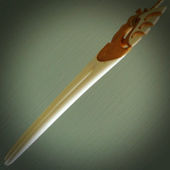 A hand carved bone and stained bone Heru comb. A large hand made Heru comb by New Zealand artist Kerry Thompson. Kerry has carved an exquisite work of art and would be perfect for an enthusiasts collection.