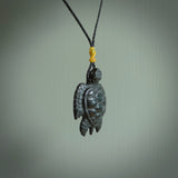 This picture shows a hand carved black jade turtle pendant. It is polished to a soft shine and has quite a lot of detail carved into the jade. The cord is a hand plaited black, waxed polyester. Carved by NZ Pacific.