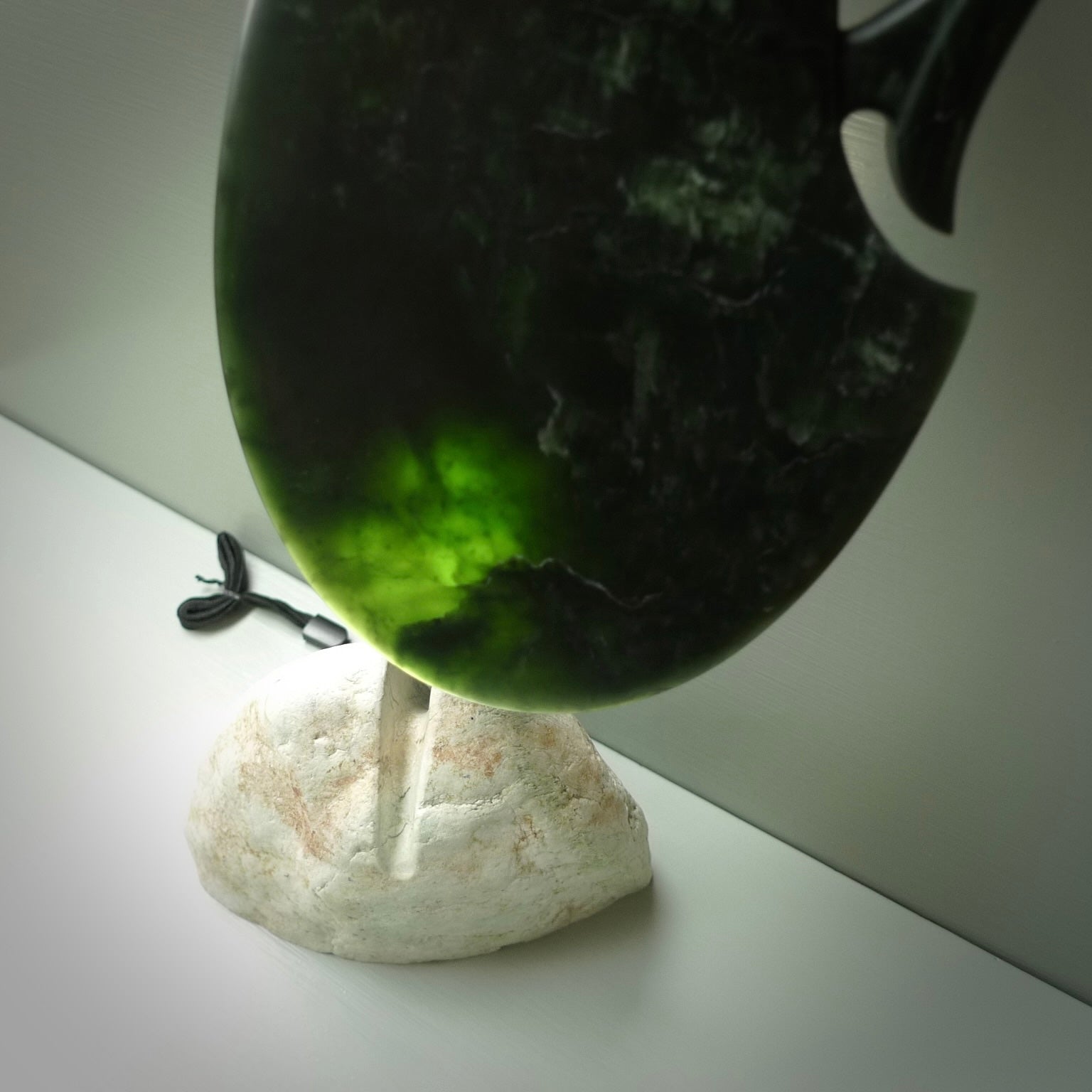 Hand carved wahaika Pounamu. Art to display. One only hand made wahaika display piece with base. New Zealand wahaika carved in Pounamu, Jade by Kerry Thompson. Free delivery worldwide.