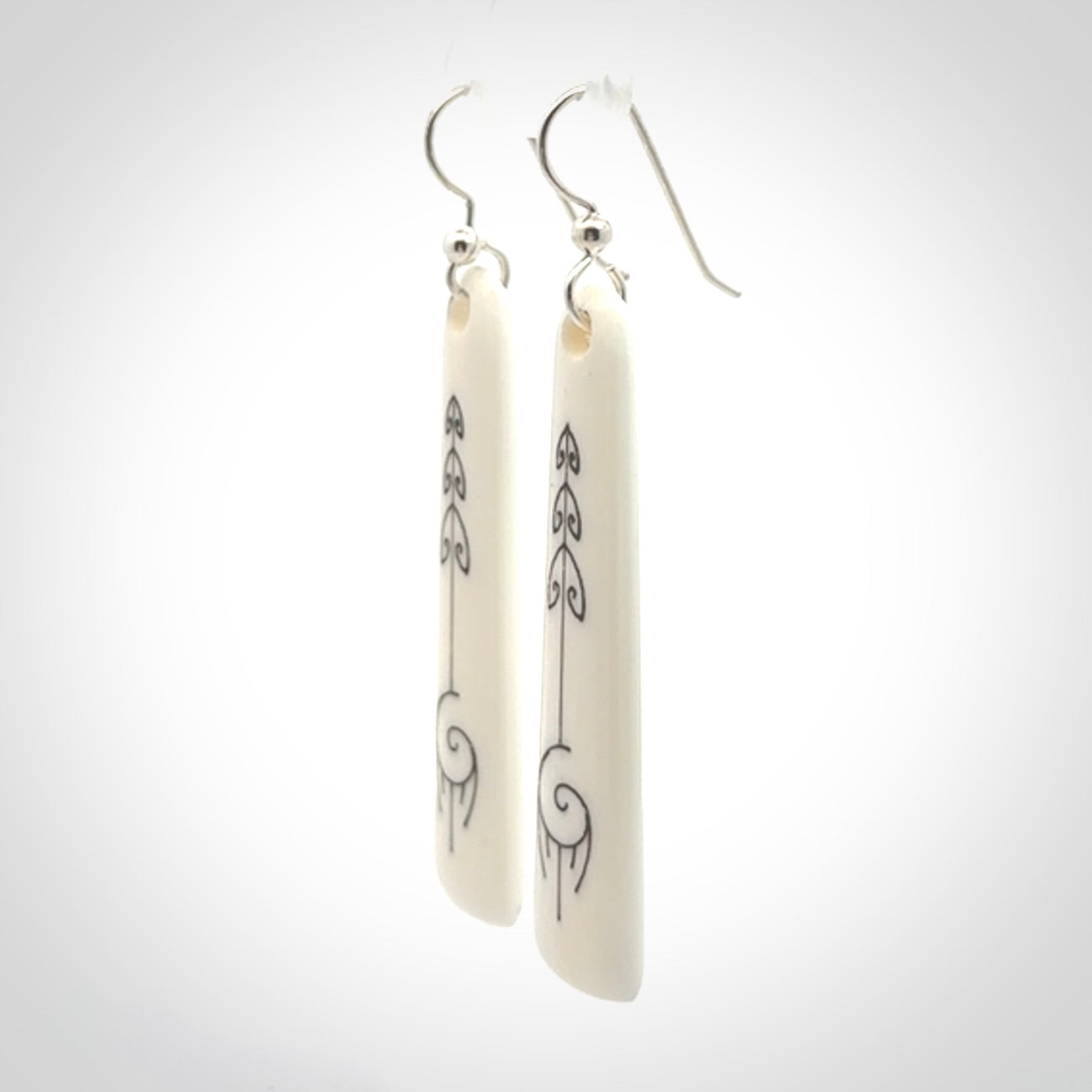 Hand carved large bone earrings with dreamcatcher engraving.