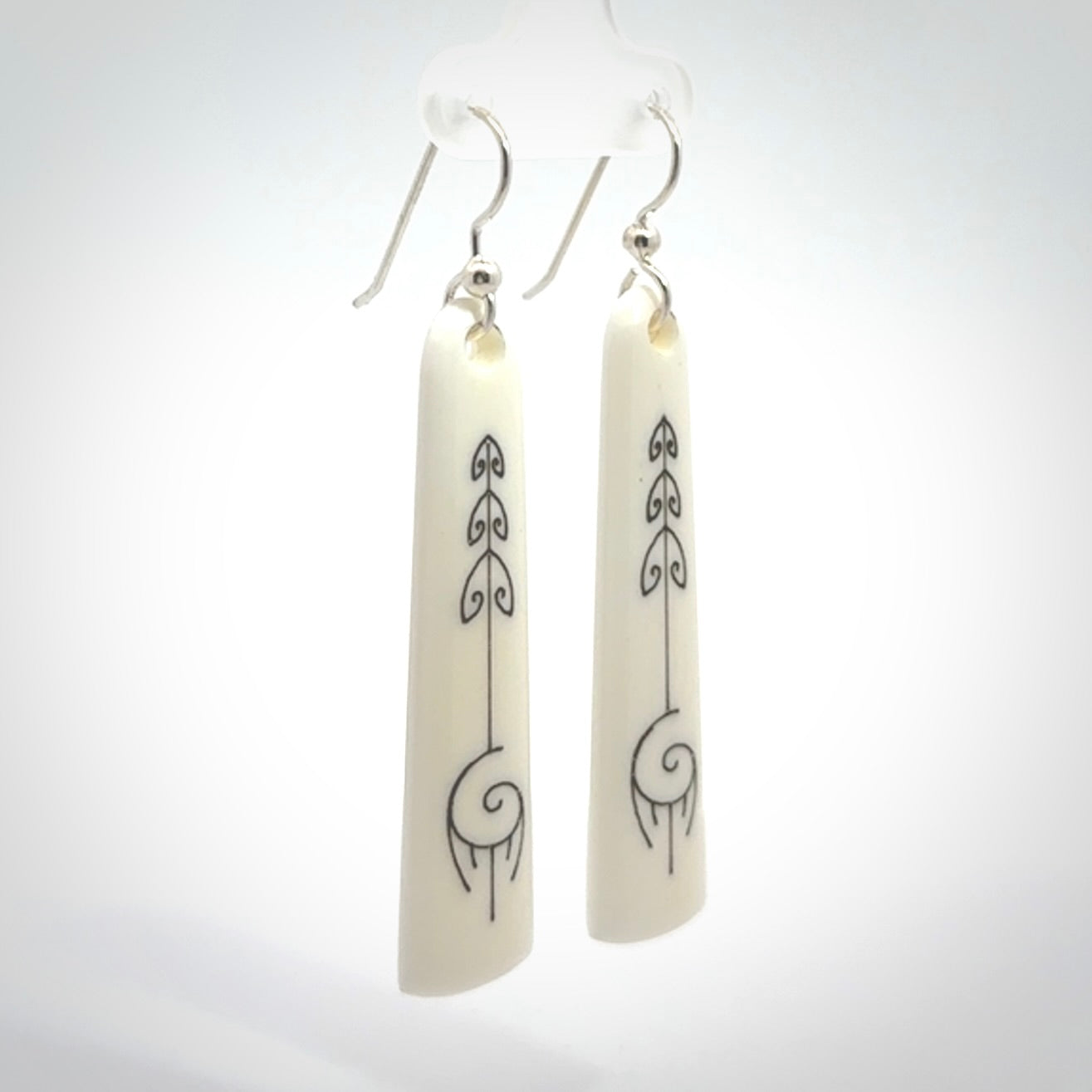 Hand carved large bone earrings with dreamcatcher engraving.