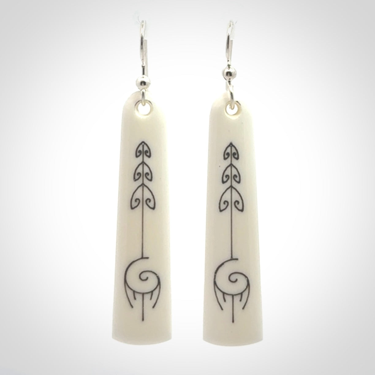 Hand carved large bone earrings with dreamcatcher engraving.