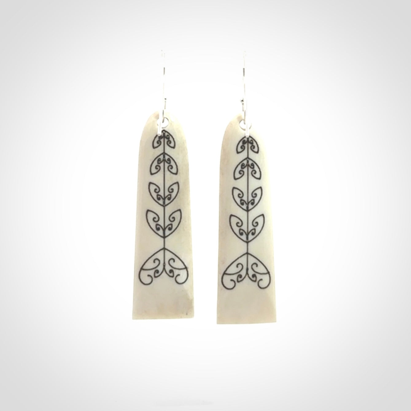 Hand carved bone koru earrings with double sided engraving.