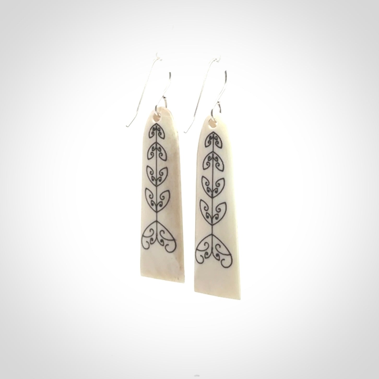 Hand carved bone koru earrings with double sided engraving.