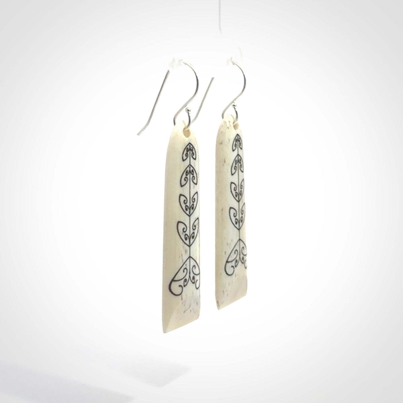Hand carved bone koru earrings with double sided engraving.