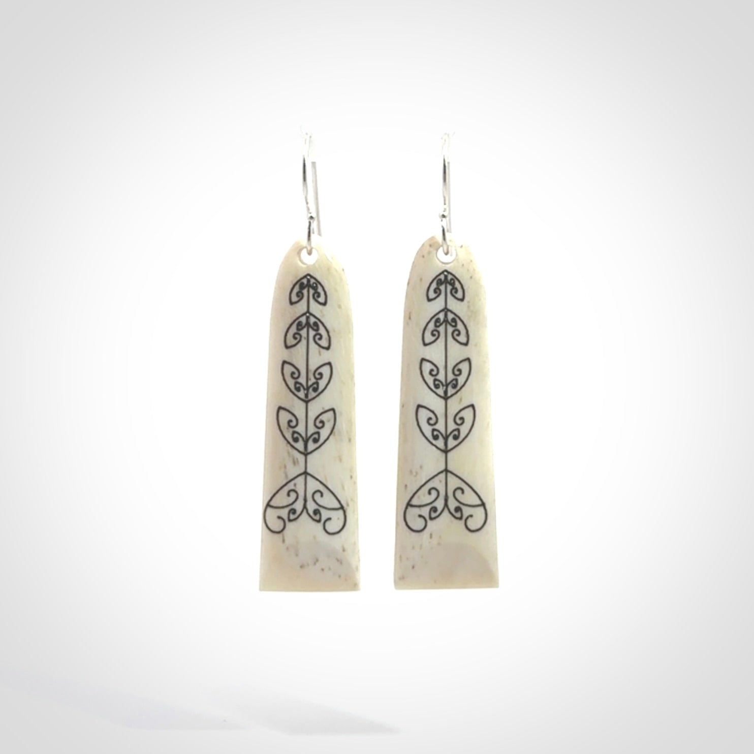 Hand carved bone koru earrings with double sided engraving.
