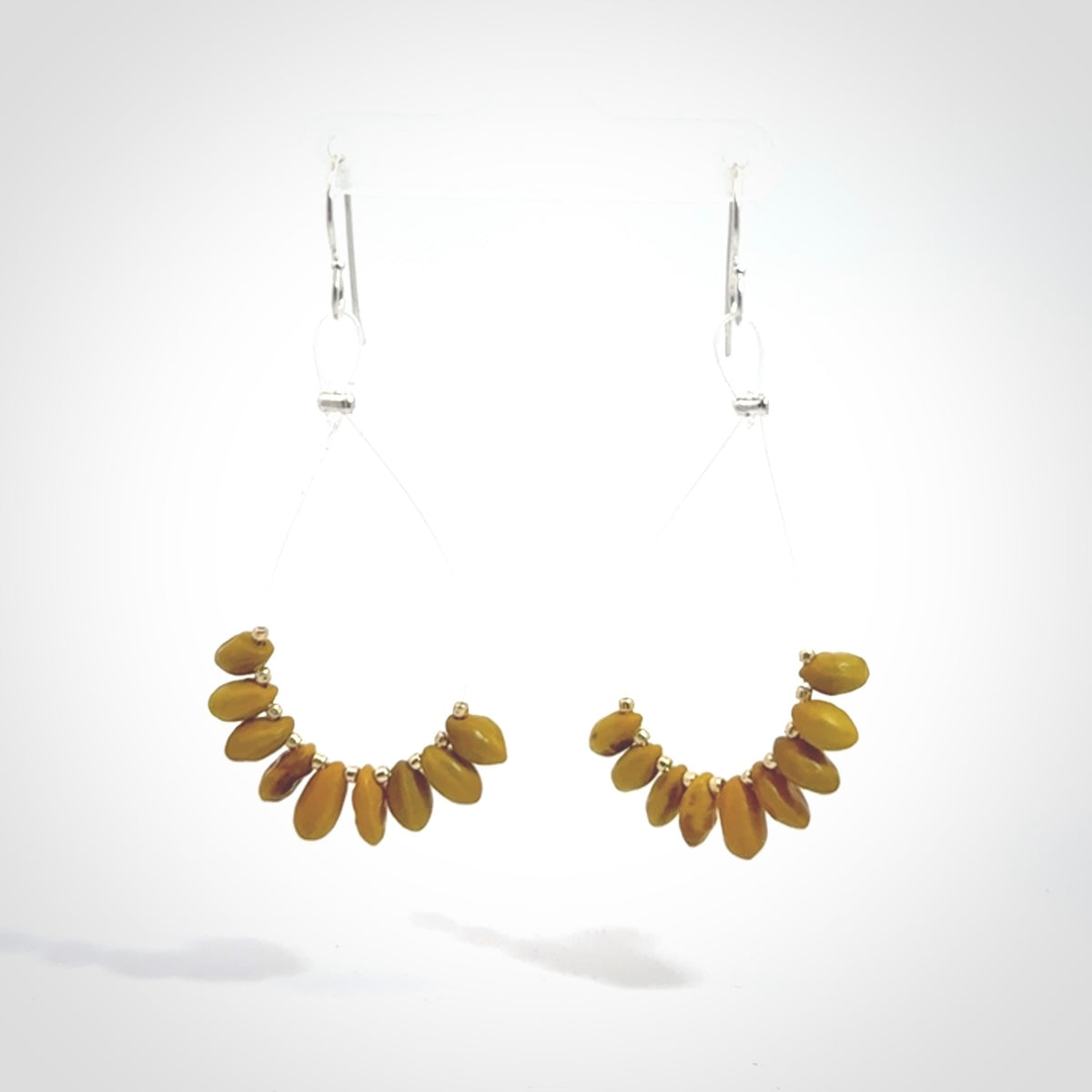 Hand carved New Zealand Kōwhai seed earrings.