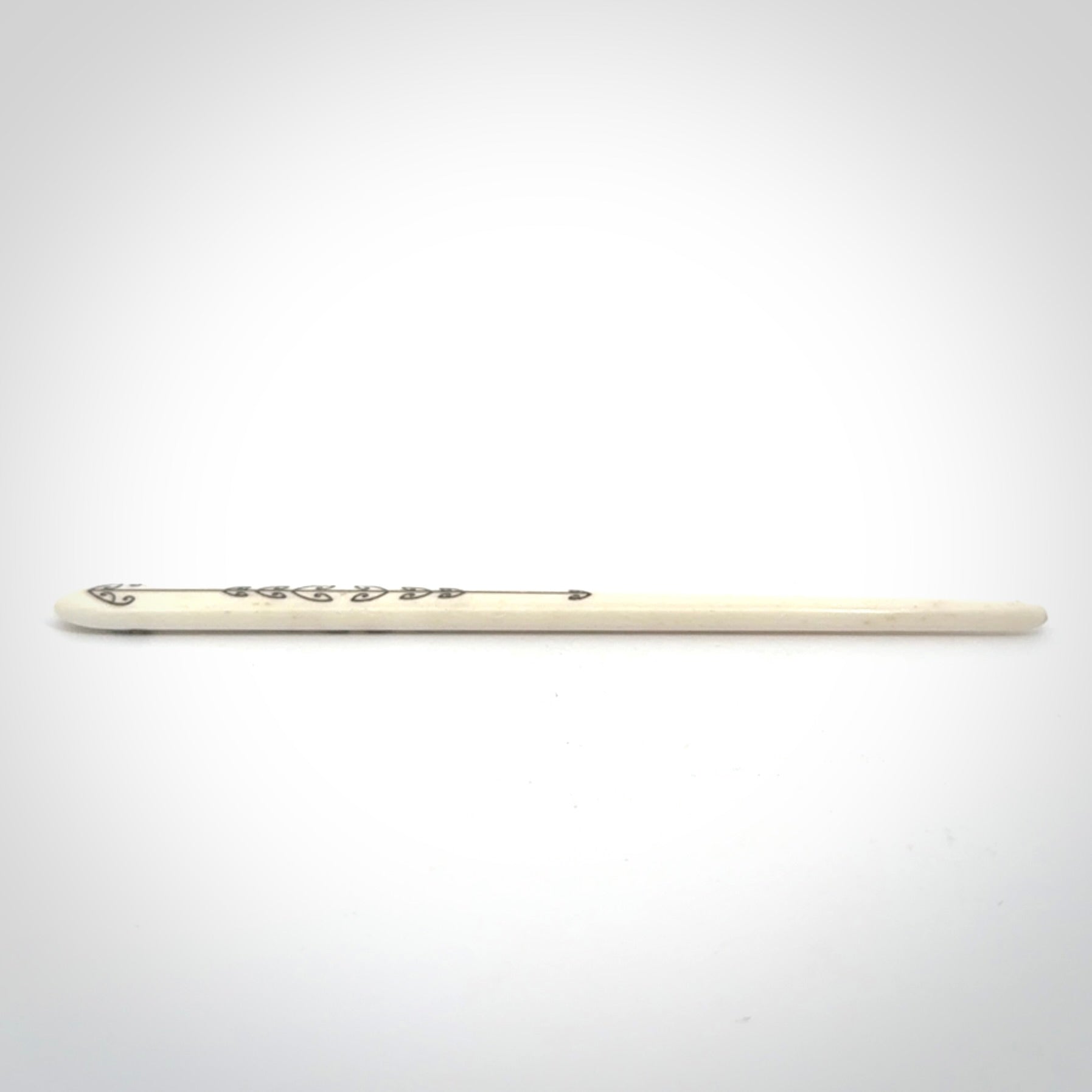 Hand carved bone hair pin with double sided koru design.