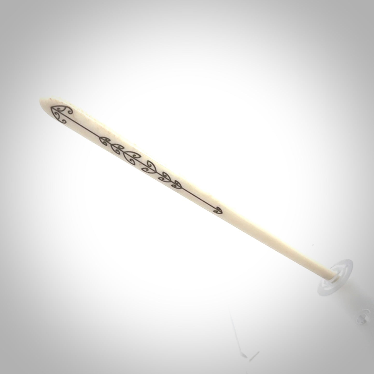 Hand carved bone hair pin with double sided koru design.