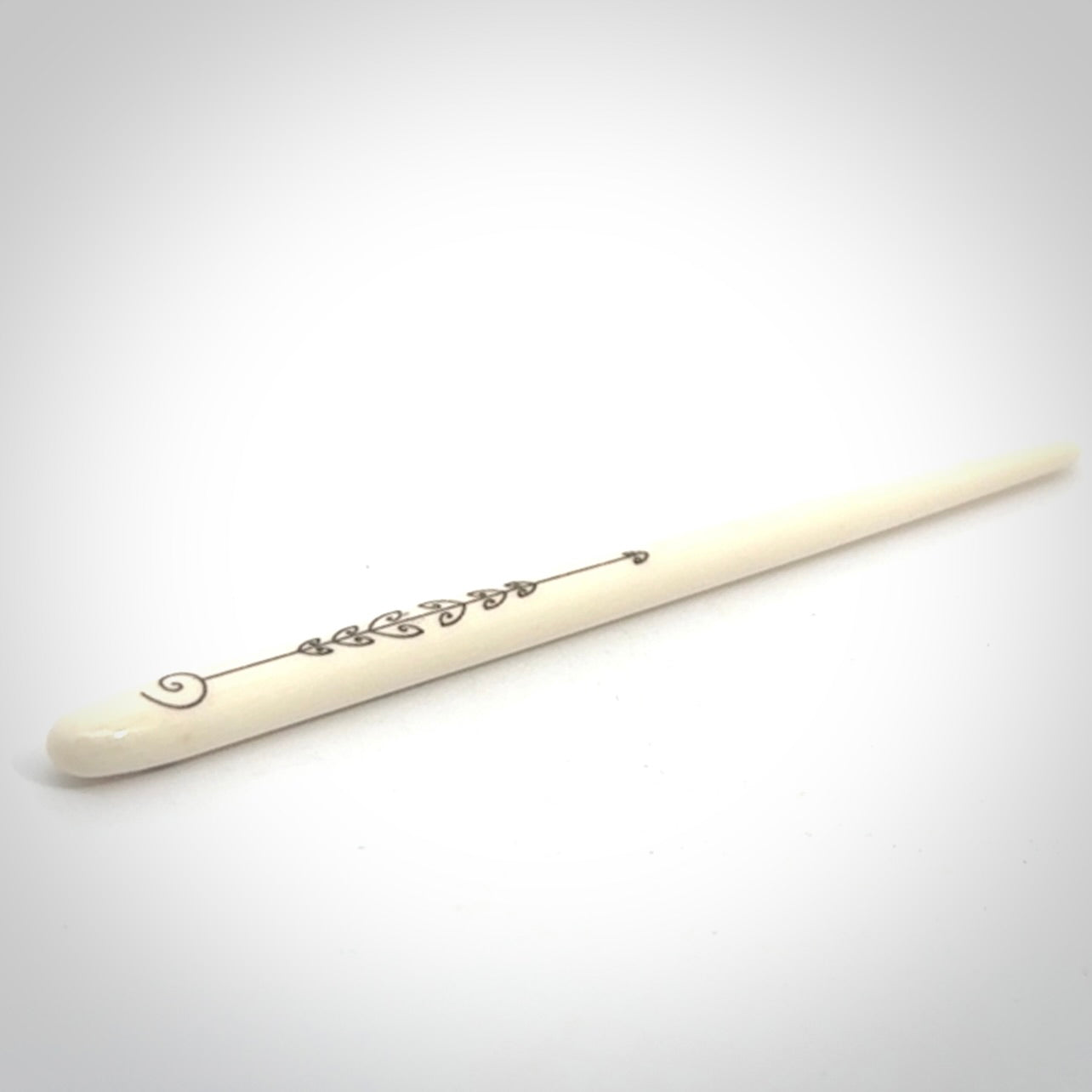 Hand carved bone hair pin with double sided koru design.