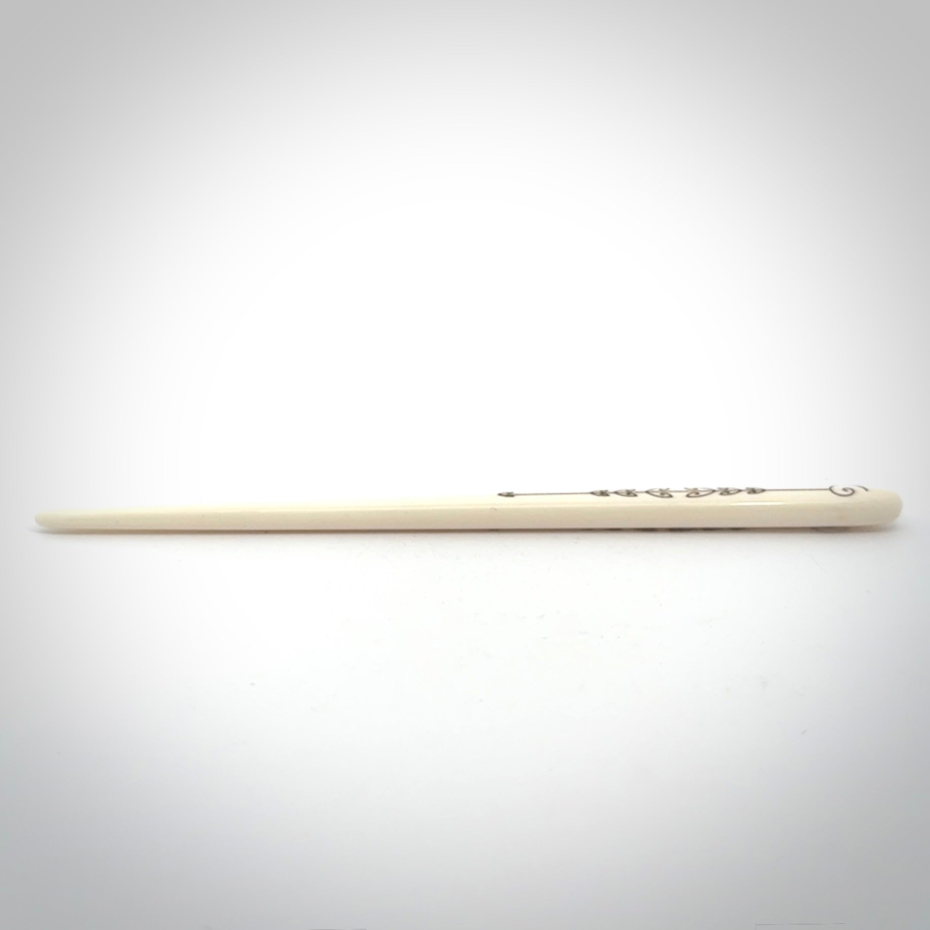 Hand carved bone hair pin with double sided koru design.