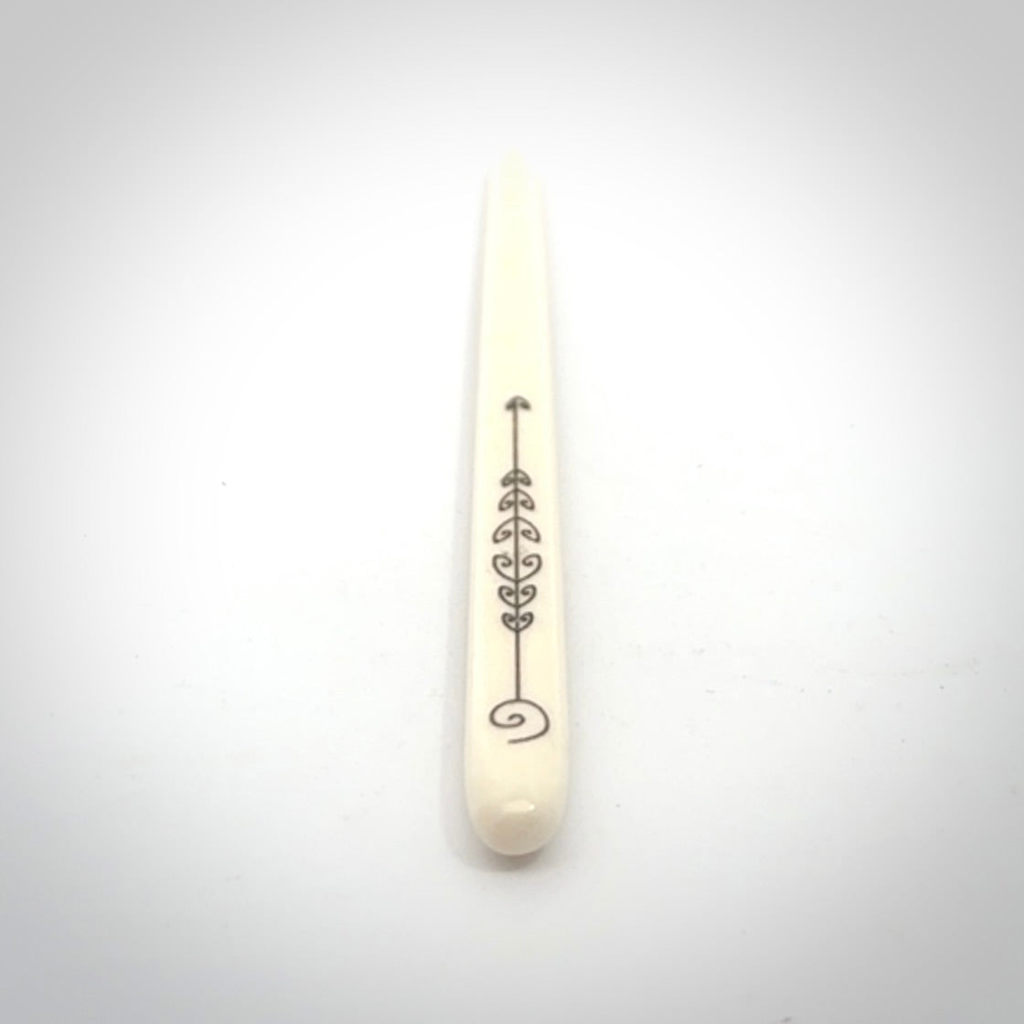 Hand carved bone hair pin with double sided koru design.