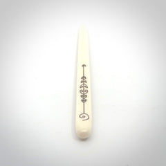 Hand carved bone hair pin with double sided koru design.
