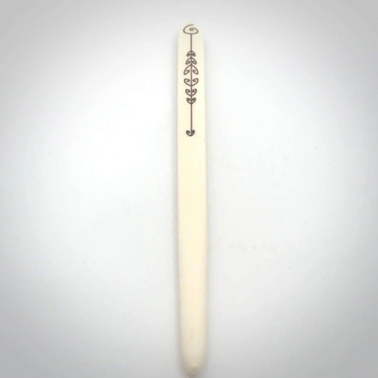 Hand carved bone hair pin with double sided koru design.