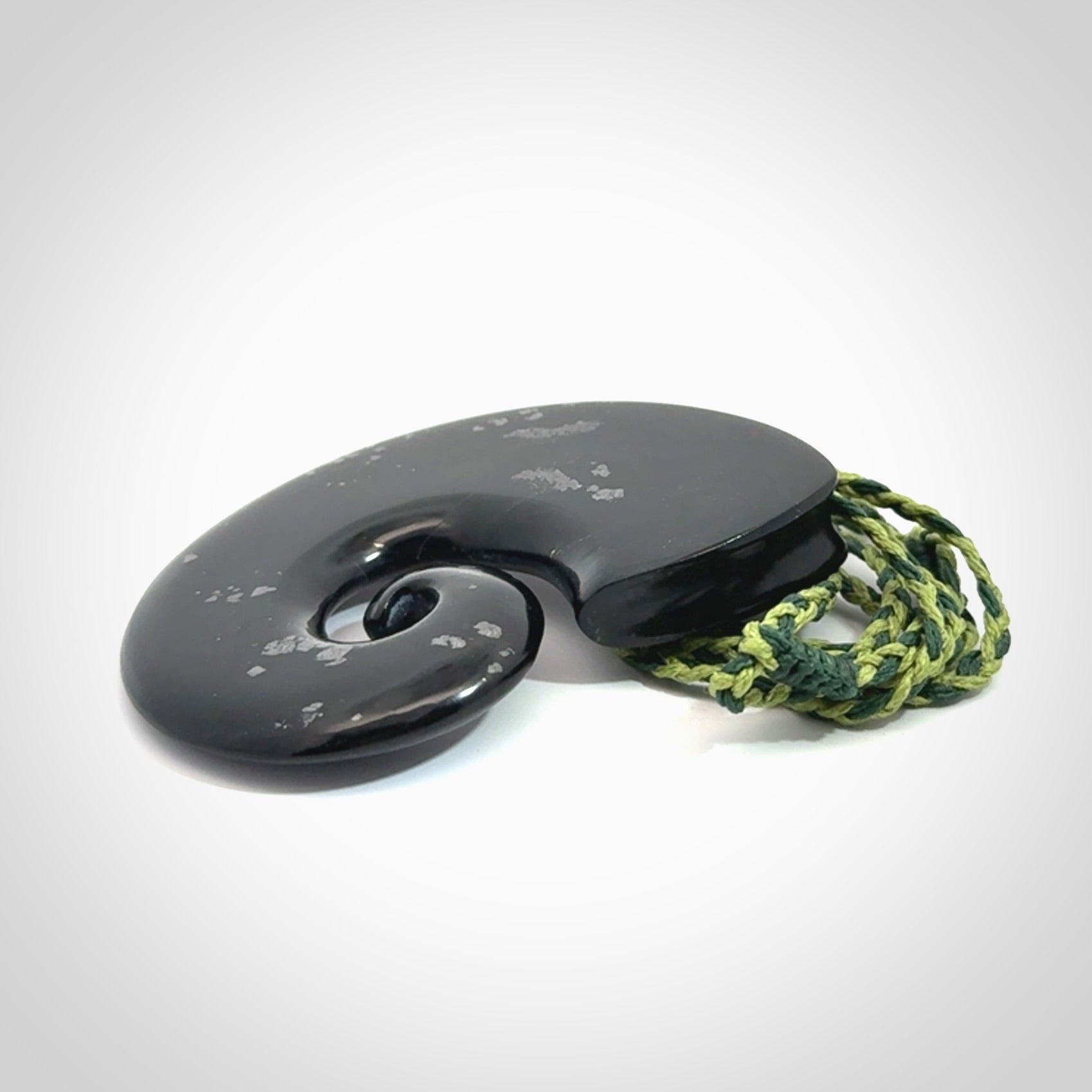 A hand carved koru pendant from New Zealand Tangiwai Pounamu. The cord is a Fern/Manuka Green colour and is an adjustable length. A large hand made Koru necklace by New Zealand artist Kerry Thompson.