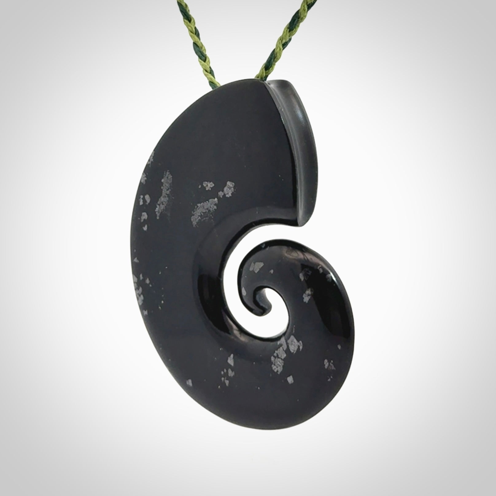 A hand carved koru pendant from New Zealand Tangiwai Pounamu. The cord is a Fern/Manuka Green colour and is an adjustable length. A large hand made Koru necklace by New Zealand artist Kerry Thompson.