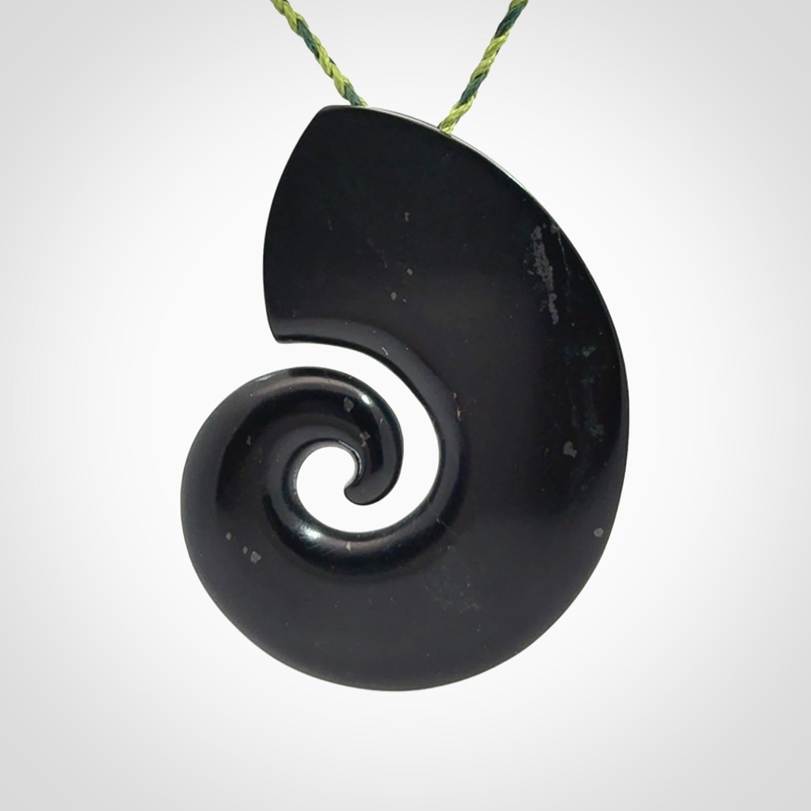 A hand carved koru pendant from New Zealand Tangiwai Pounamu. The cord is a Fern/Manuka Green colour and is an adjustable length. A large hand made Koru necklace by New Zealand artist Kerry Thompson.