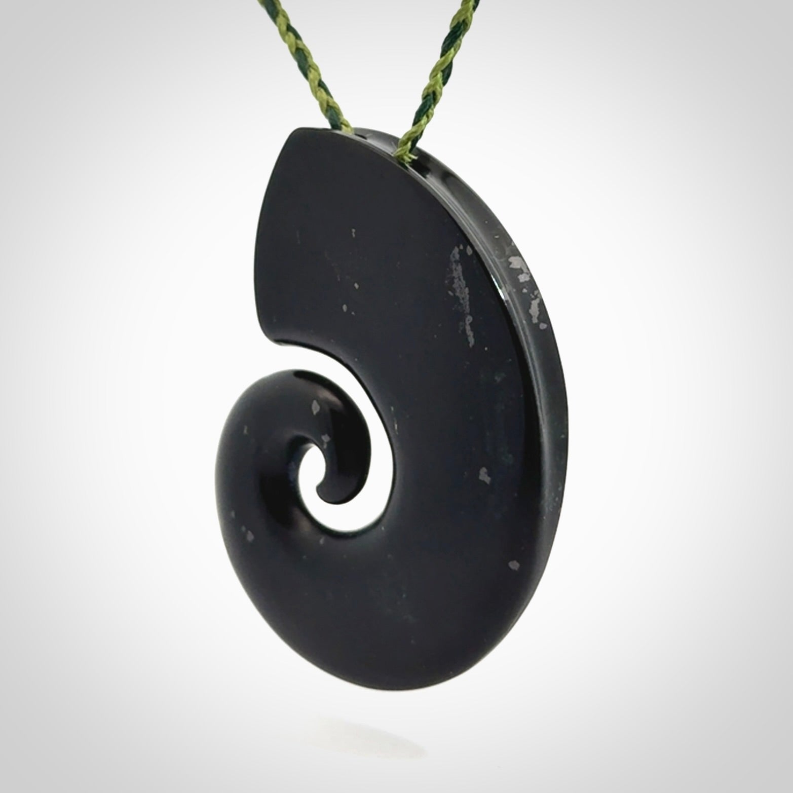 A hand carved koru pendant from New Zealand Tangiwai Pounamu. The cord is a Fern/Manuka Green colour and is an adjustable length. A large hand made Koru necklace by New Zealand artist Kerry Thompson.
