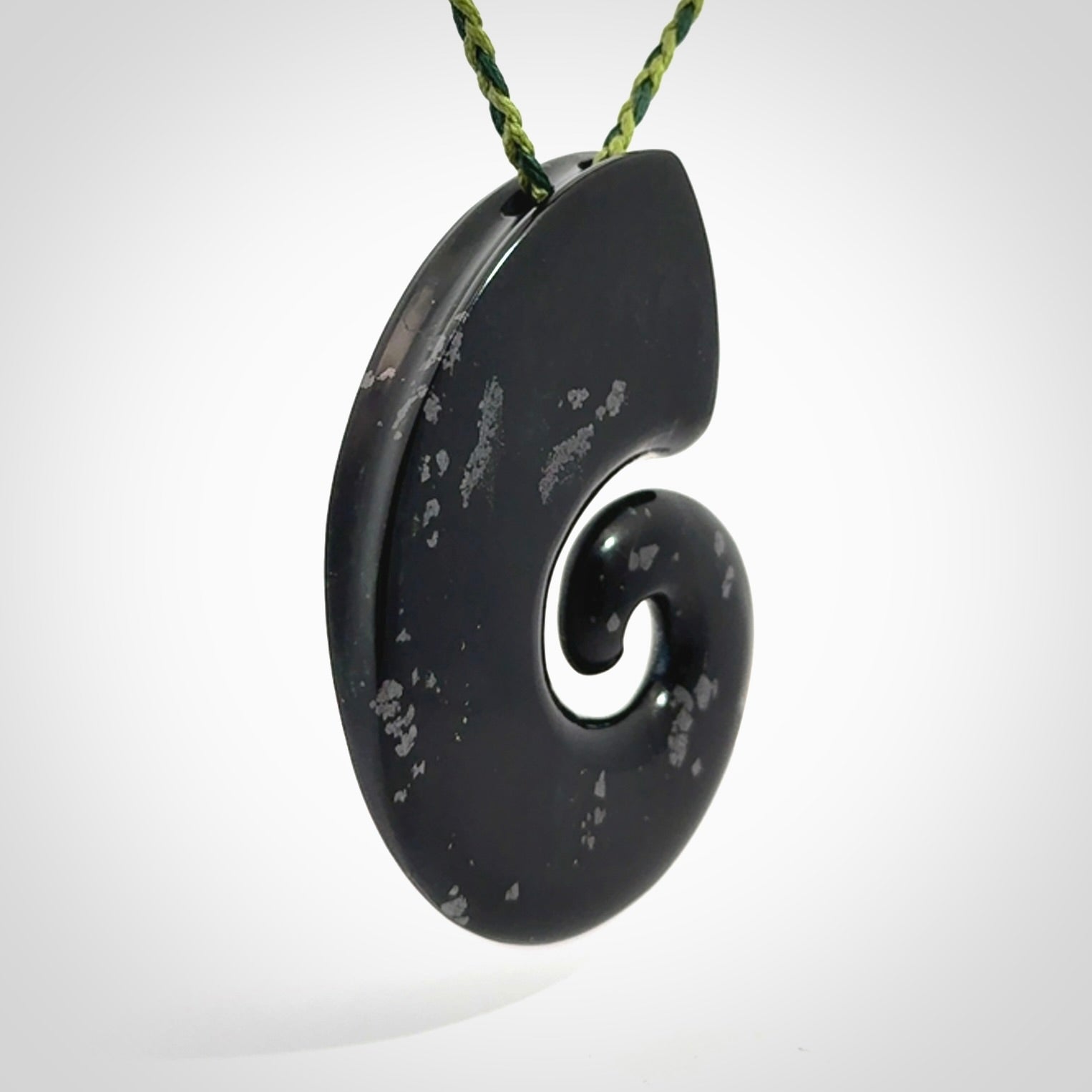 A hand carved koru pendant from New Zealand Tangiwai Pounamu. The cord is a Fern/Manuka Green colour and is an adjustable length. A large hand made Koru necklace by New Zealand artist Kerry Thompson.