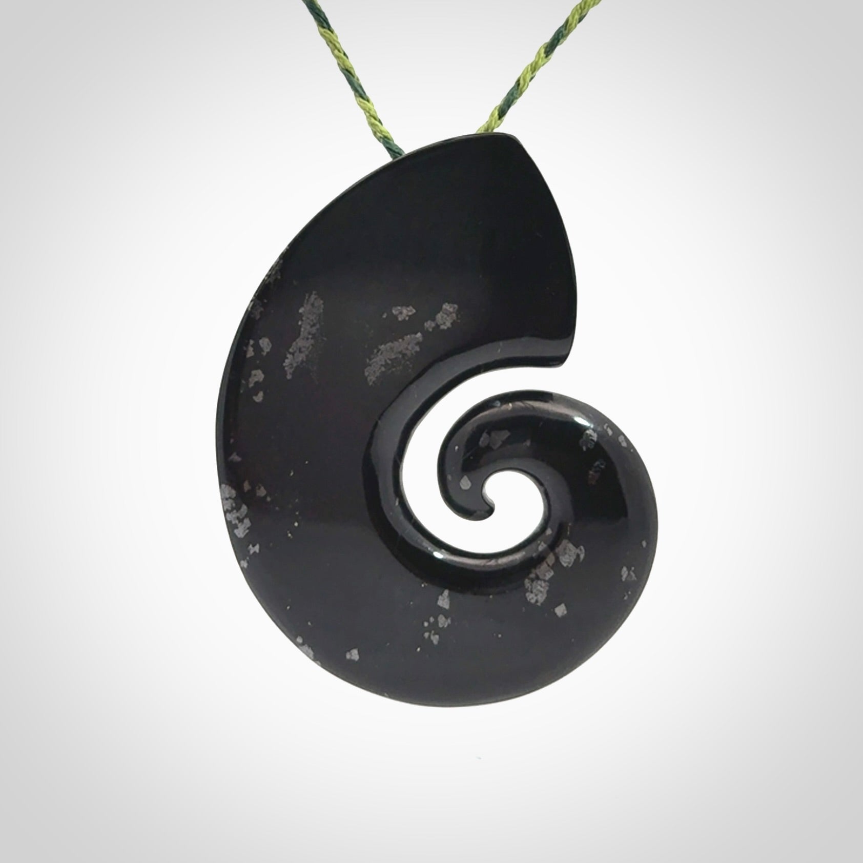 A hand carved koru pendant from New Zealand Tangiwai Pounamu. The cord is a Fern/Manuka Green colour and is an adjustable length. A large hand made Koru necklace by New Zealand artist Kerry Thompson.