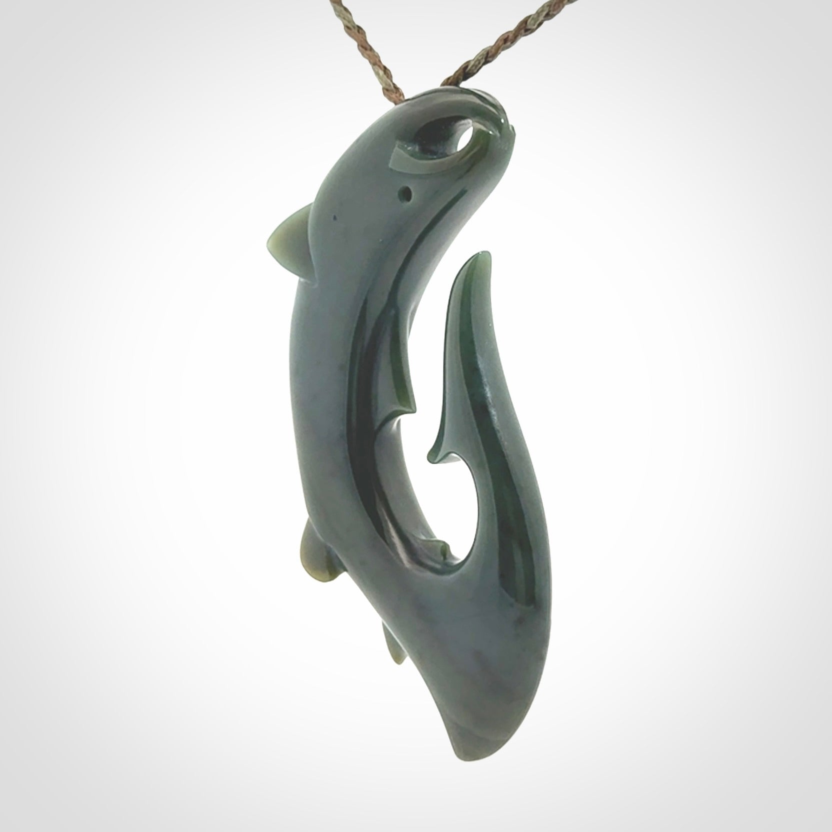 Hand carved New Zealand Inanga Jade salmon fish hook pendant.