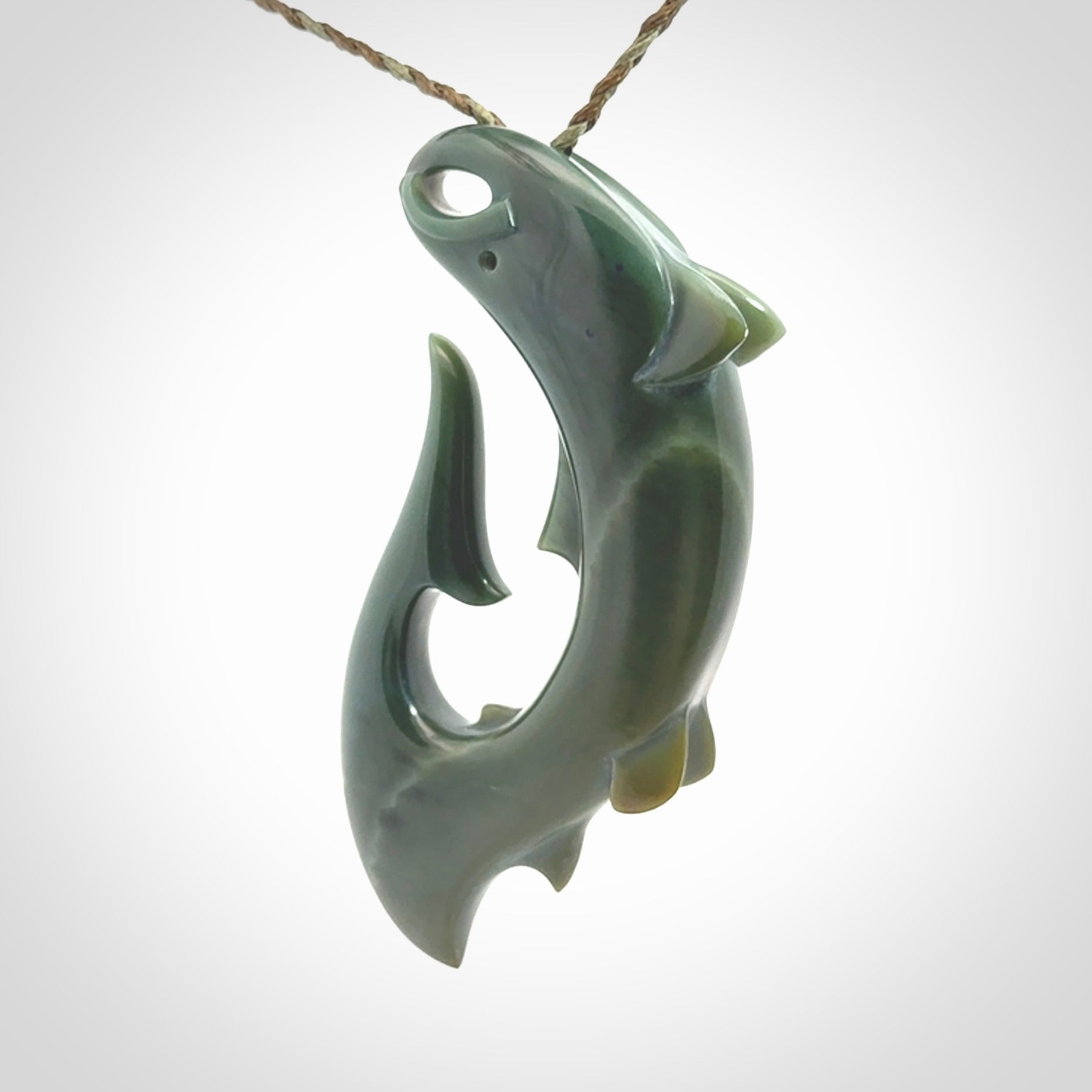 Hand carved New Zealand Inanga Jade salmon fish hook pendant.