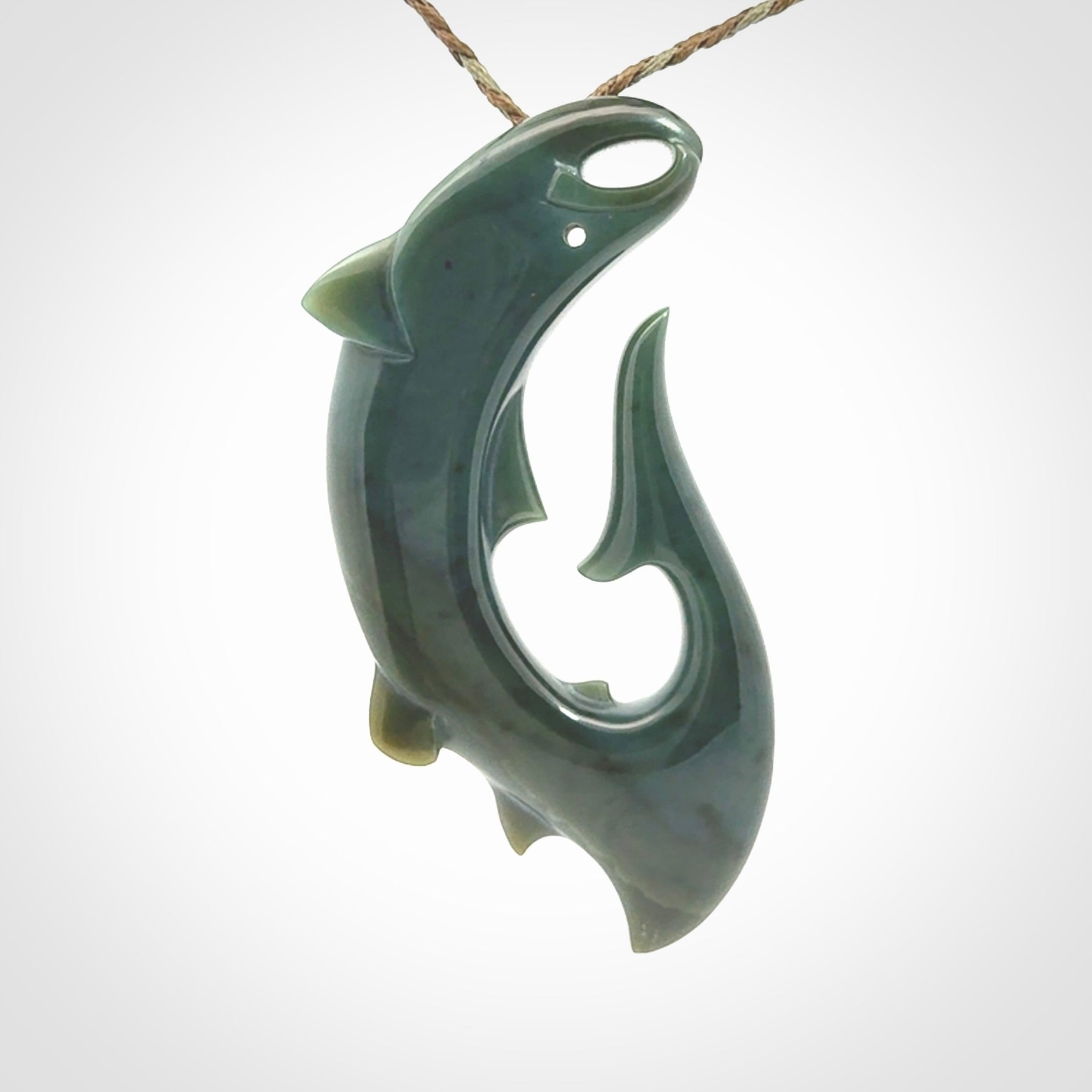 Hand carved New Zealand Inanga Jade salmon fish hook pendant.
