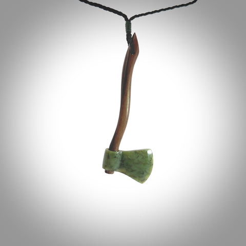 A striking hand carved axe pendant that we've called the Lumberjack. These are carved with a jade head and a hardwood handle. The cords are hand plaited in our waxed polyester which is robust, strong and durable. We ship these worldwide with DHL express courier.