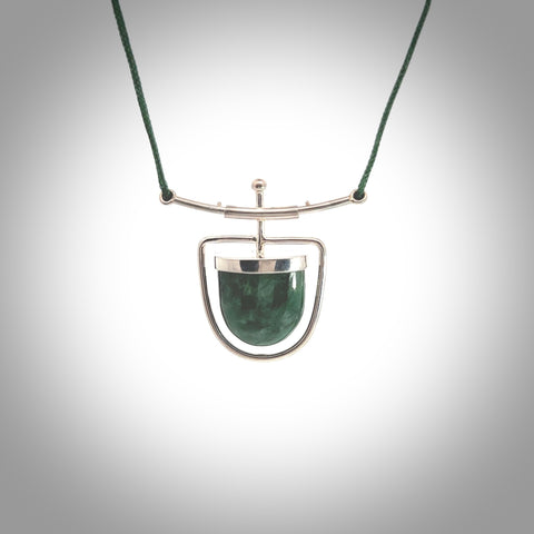 Hand crafted contemporary green jade and sterling silver drop necklace. This necklace is provided with a green adjustable cord. Contemporary green jade drop necklace with sterling silver.
