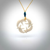 Hand carved natural bone four whale pendant. Art to wear. Ocean themed pendants.