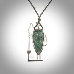 This is a very cool and creative fisherman hand made from New Zealand Jade and Sterling Silver. A fisherman who had caught a fish pendant hand crafted from sterling silver with Jade torso. A spectacular piece of art to wear.