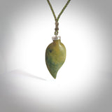 This picture shows a leaf shaped pendant, hand carved from New Zealand flower jade. It has a silver cap with loop on the top for a cord or a chain. We will provide this with an adjustable plaited cord.