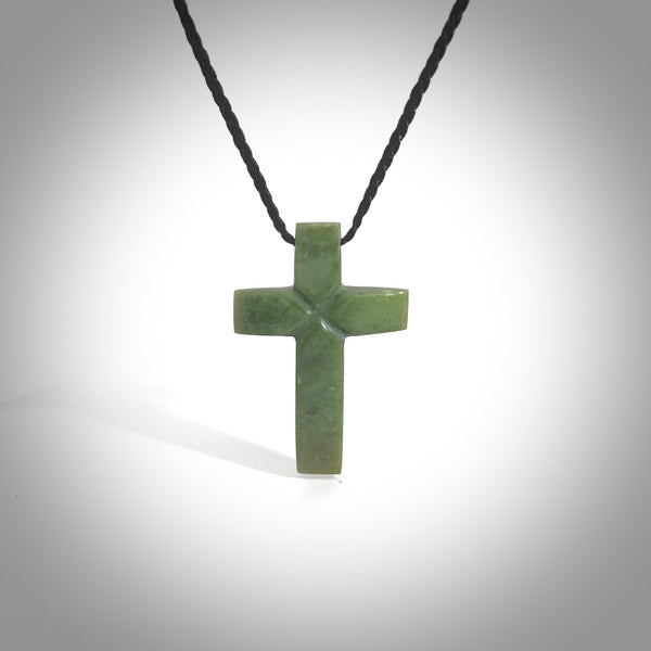 Hand carved New Zealand jade cross necklace. Religious symbol pendant. Christian cross pendant for sale online. Hand crafted from New Zealand Jade Pounamu, free worldwide delivery.