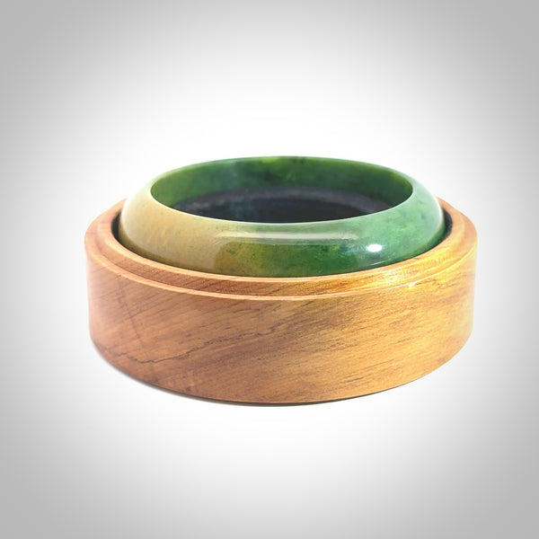 Hand carved jade bangle. Carved from green New Zealand jade. This is a solid jade bangle carved from a single piece of jade. It is polished to a soft shine. the jade is otherwise untreated and completely natural.