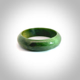 New Zealand flower jade bangle. This is carved from a solid piece of jade and polished to a mirror finish on the outside. The inside is a satin finish. The jade is high grade New Zealand Marsden and is a beautiful coloured stone.