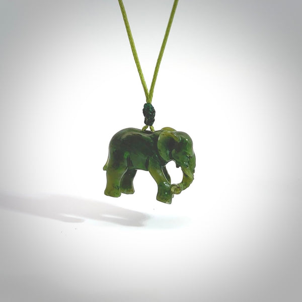 This is a handcarved elephant. Carved in a beautiful darker green piece of New Zealand jade. The cord is black, hand-plaited and length adjustable. One only piece of art to wear.