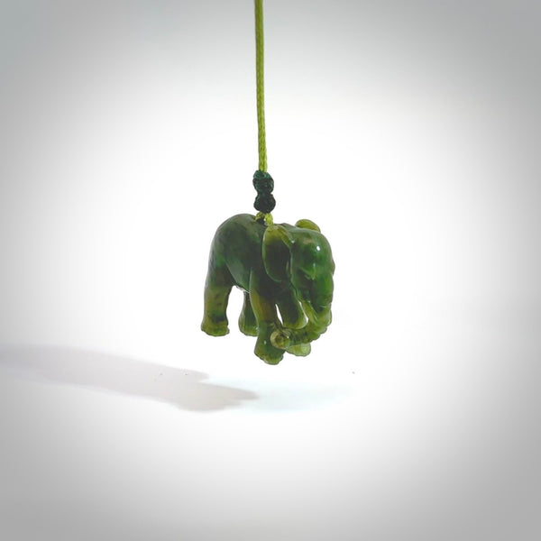 This is a handcarved elephant. Carved in a beautiful darker green piece of New Zealand jade. The cord is black, hand-plaited and length adjustable. One only piece of art to wear.