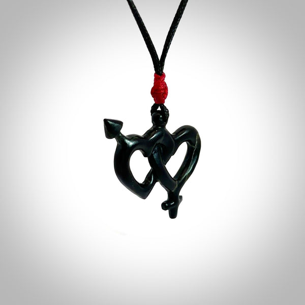 Hand carved double heart pendant made in your choice of black jade or jasper stone. Made by NZ Pacific. Carved from Red Jasper Stone and Black Jade. Black jade and red jasper stone heart with his and her symbols. Free delivery worldwide.