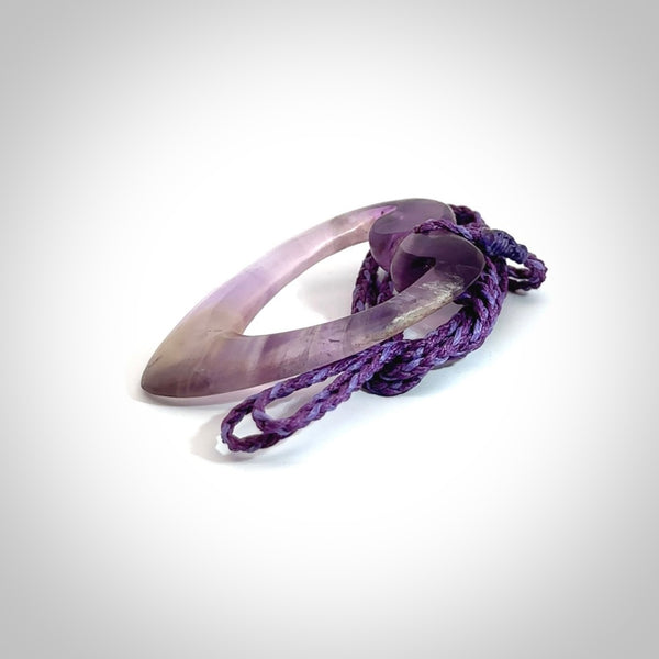 Hand carved Amethyst Crystal contemporary heart pendant. Carved by NZ Pacific in Amethyst Crystal. This is a modern heart pendant made from natural materials.