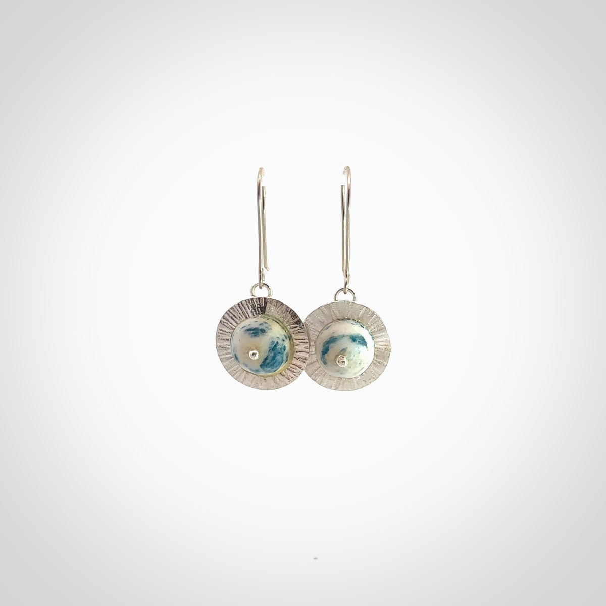 These are a pair of beautiful Aotea Stone and sterling silver earrings. It is carved from Aotea Stone from New Zealand. It is a light blue and white colour with sterling silver. Hand made here in New Zealand by Ana Krakosky.